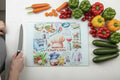 A square ceramic tile featuring a colorful retro-style illustration titled 'Chef's Life' with cooking utensils, ingredients, and kitchen scenes on a white background, standing on a yellow surface against a white wall.