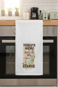 White towel with humorous text and graphics on a black surface