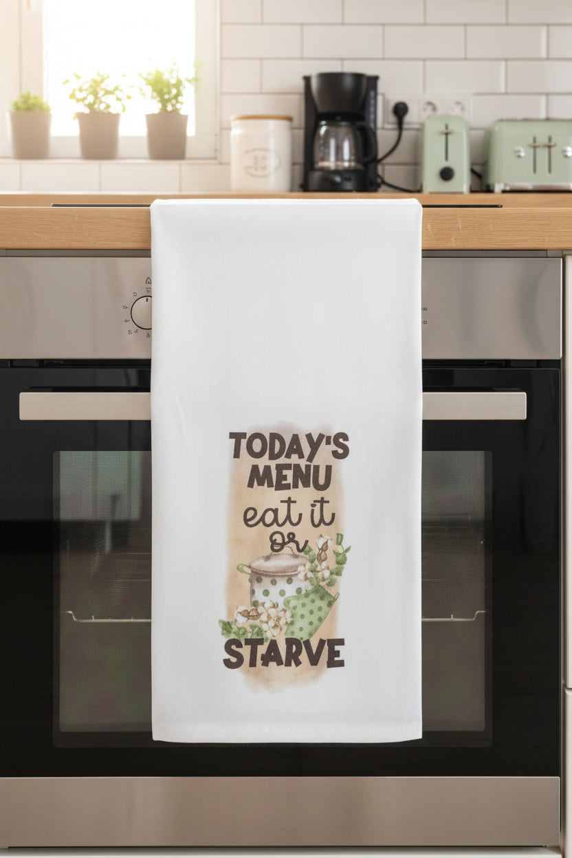 White towel with humorous text and graphics on a black surface